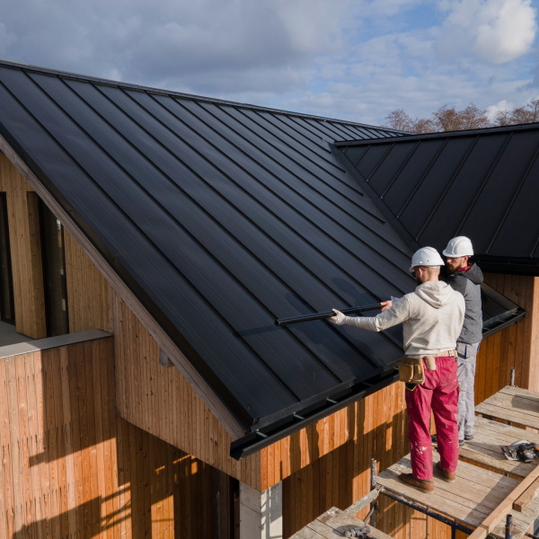 full shot roofers working together with helmets